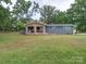 Lovely single-story home boasts a welcoming stone porch and a spacious, green front yard at 6604 Plyler Mill Rd, Monroe, NC 28112
