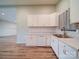 Bright kitchen with white cabinets, updated appliances, and a modern tile backsplash at 6604 Plyler Mill Rd, Monroe, NC 28112