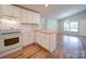 Bright kitchen features white cabinets, updated appliances, butcher block island, and hardwood flooring at 6604 Plyler Mill Rd, Monroe, NC 28112