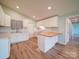 Bright kitchen features white cabinets, updated appliances, butcher block island, and hardwood flooring at 6604 Plyler Mill Rd, Monroe, NC 28112