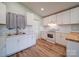 Bright kitchen features white cabinets, stainless steel sink, and modern appliances at 6604 Plyler Mill Rd, Monroe, NC 28112