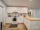 Bright kitchen with white cabinets, butcher block island, and modern backsplash at 6604 Plyler Mill Rd, Monroe, NC 28112