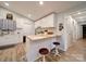 Charming kitchen featuring white cabinets, butcher block countertop, and bar stool seating at 6604 Plyler Mill Rd, Monroe, NC 28112