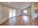Bright living room with hardwood floors, recessed lighting, and sliding glass door at 6604 Plyler Mill Rd, Monroe, NC 28112