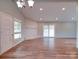 Open living room boasts ample lighting and a brick fireplace at 6604 Plyler Mill Rd, Monroe, NC 28112