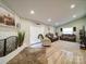 Bright living room featuring a fireplace, neutral decor, and modern flooring at 6604 Plyler Mill Rd, Monroe, NC 28112