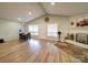 Open living and dining area with wood floors and a brick fireplace, perfect for entertaining at 6604 Plyler Mill Rd, Monroe, NC 28112