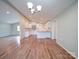 Open-concept living space featuring wood floors, recessed lighting, and a modern kitchen at 6604 Plyler Mill Rd, Monroe, NC 28112