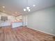 Open-concept living area featuring wood floors, recessed lighting, and a modern kitchen at 6604 Plyler Mill Rd, Monroe, NC 28112