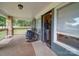 View of the covered porch with a stone facade and rocking chairs at 6604 Plyler Mill Rd, Monroe, NC 28112
