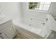 Bright bathroom featuring a white built in tub with chrome fixtures at 6640 Autumn Gate Ln, Charlotte, NC 28216