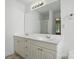 Bright bathroom featuring double sinks, white cabinets, a large mirror, and chrome fixtures at 6640 Autumn Gate Ln, Charlotte, NC 28216