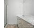 Bathroom featuring a glass-enclosed shower and double sinks with chrome fixtures at 6640 Autumn Gate Ln, Charlotte, NC 28216