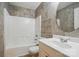 Well-lit bathroom with a shower-tub combo, tiled walls, and a modern vanity at 6640 Autumn Gate Ln, Charlotte, NC 28216