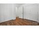 Bright bedroom featuring sleek wood floors and two closets at 6640 Autumn Gate Ln, Charlotte, NC 28216