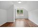Bright bedroom features hardwood floors, natural light from a window, and neutral walls at 6640 Autumn Gate Ln, Charlotte, NC 28216