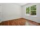 Bright bedroom featuring sleek wood floors and a large window at 6640 Autumn Gate Ln, Charlotte, NC 28216