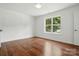 Bedroom with hardwood floors and natural light from large window at 6640 Autumn Gate Ln, Charlotte, NC 28216