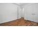 Bright bedroom featuring sleek wood floors and access to two closets and the main hallway at 6640 Autumn Gate Ln, Charlotte, NC 28216