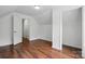 Bedroom with wood floors, a closet, and a door leading to other rooms at 6640 Autumn Gate Ln, Charlotte, NC 28216