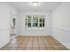 Dining room with tile flooring, large window providing lots of light, and white trim at 6640 Autumn Gate Ln, Charlotte, NC 28216
