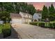 Inviting two-story home with a spacious driveway and manicured landscaping at sunset at 6640 Autumn Gate Ln, Charlotte, NC 28216