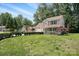 Beautiful two-story home with lush green lawn and mature trees on a sunny day at 6640 Autumn Gate Ln, Charlotte, NC 28216