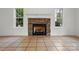 Close-up of a stone fireplace with a classic mantel and tile flooring at 6640 Autumn Gate Ln, Charlotte, NC 28216