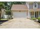 Attached two-car garage with a wide driveway and manicured landscaping at 6640 Autumn Gate Ln, Charlotte, NC 28216