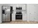 Kitchen with stainless steel appliances, white cabinets and subway tile backsplash at 6640 Autumn Gate Ln, Charlotte, NC 28216