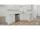 Bright kitchen with white cabinets, stainless steel dishwasher, subway tile backsplash and tile floors at 6640 Autumn Gate Ln, Charlotte, NC 28216