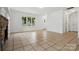 Bright living room features tile floors, a stone fireplace, and a large window at 6640 Autumn Gate Ln, Charlotte, NC 28216
