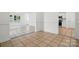 Bright living room flows into kitchen with tile flooring and white trim at 6640 Autumn Gate Ln, Charlotte, NC 28216