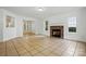 Spacious living room with a cozy stone fireplace and tile flooring at 6640 Autumn Gate Ln, Charlotte, NC 28216