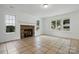 Bright living room featuring a stone fireplace and natural light from multiple windows at 6640 Autumn Gate Ln, Charlotte, NC 28216