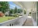 Inviting covered front porch with white columns and views of the landscaped yard at 6640 Autumn Gate Ln, Charlotte, NC 28216