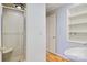 Clean bathroom with glass-door shower, wood floors, and built-in shelving at 6664 Lake Shore Dr, Hickory, NC 28601