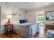 Comfortable bedroom with hardwood floors, a view to a lake, and an inviting sunny screened-in porch at 6664 Lake Shore Dr, Hickory, NC 28601