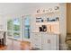 Kitchen area featuring white cabinets and countertops, coffee bar, and a door leading to the patio at 6664 Lake Shore Dr, Hickory, NC 28601