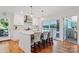Bright kitchen with white cabinets, a stainless hood, hardwood floors, and waterfront views at 6664 Lake Shore Dr, Hickory, NC 28601