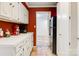 Galley kitchen with white cabinets, tile floors, and pass-through to another room at 6664 Lake Shore Dr, Hickory, NC 28601