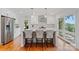 Modern kitchen featuring white cabinets, stainless steel appliances, hardwood floors, and waterfront views at 6664 Lake Shore Dr, Hickory, NC 28601
