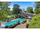 An inviting in-ground pool is surrounded by a wooden deck and mature landscaping at 6664 Lake Shore Dr, Hickory, NC 28601