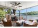 Screened porch with a ceiling fan, fireplace, comfortable seating, and waterfront views at 6664 Lake Shore Dr, Hickory, NC 28601