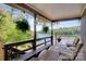 Relaxing porch featuring a bench, chairs, ferns, and scenic lake views at 6664 Lake Shore Dr, Hickory, NC 28601
