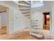 Modern staircase with a circular design, carpeted treads, and bright natural light at 6664 Lake Shore Dr, Hickory, NC 28601