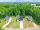 Aerial view of property showcasing large lot, mature trees, adjacent homes, and circular driveway at 7728 Shalom Dr, Charlotte, NC 28216