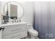Modern bathroom featuring a stylish vanity, round mirror, and minimalist fixtures, creating a clean and refreshing space at 7728 Shalom Dr, Charlotte, NC 28216