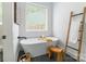 Elegant bathroom featuring a freestanding tub, stylish stool, and sleek black marble flooring at 7728 Shalom Dr, Charlotte, NC 28216