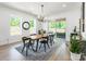 Dining room featuring a wooden table, black chairs, modern lighting, and sliding glass doors to the patio at 7728 Shalom Dr, Charlotte, NC 28216